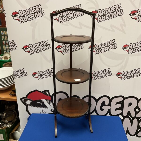 Vintage mahogany three-tier folding cake stand for display.