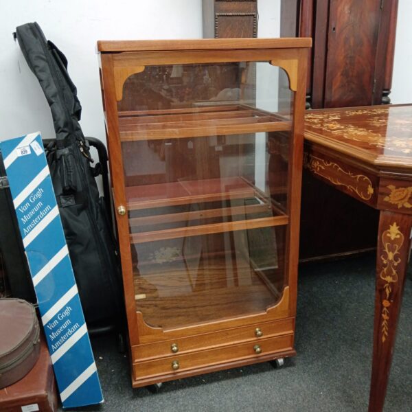 Vintage mahogany display cabinet with glazed front and drawers.