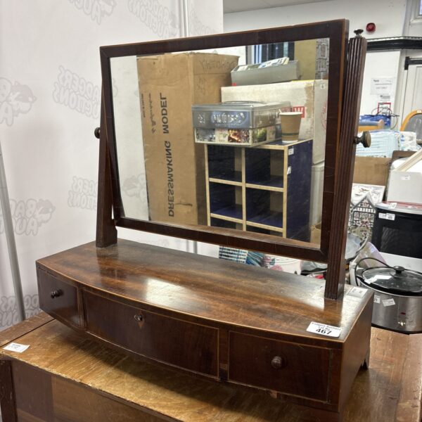 Vintage mahogany dressing table mirror with curved drawers.