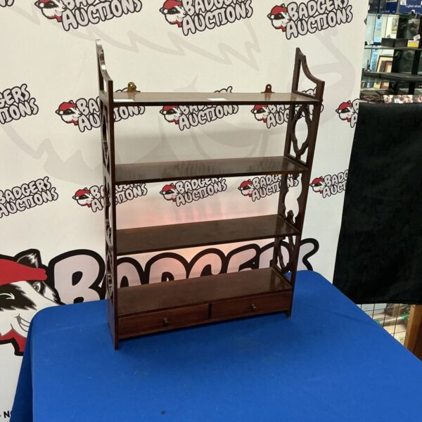 Vintage mahogany shelf cabinet with drawer for display and storage.