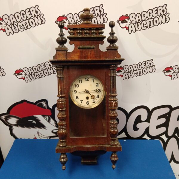 Vintage mahogany wall clock with Roman numerals, antique timekeeping.