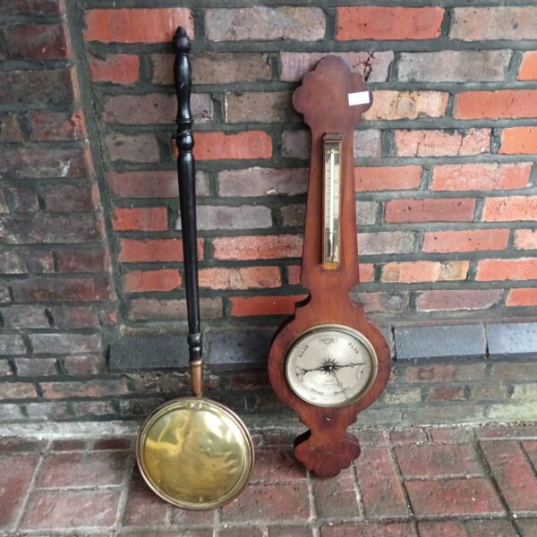 Vintage mercury barometer with copper bedpan, antique weather instrument.