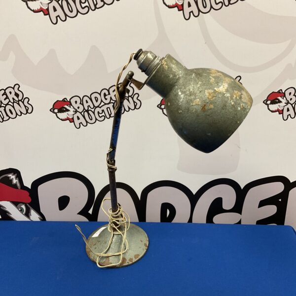 Vintage metal desk lamp with adjustable shade, ideal for restoration.