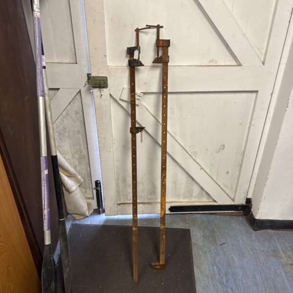 Vintage metal sash clamps for woodworking, showing signs of age.