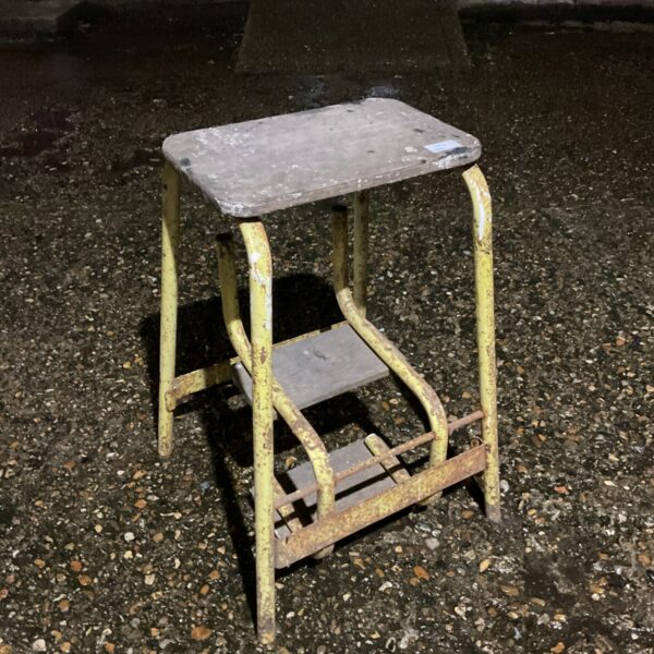 Vintage metal step stool with two steps, showing wear.