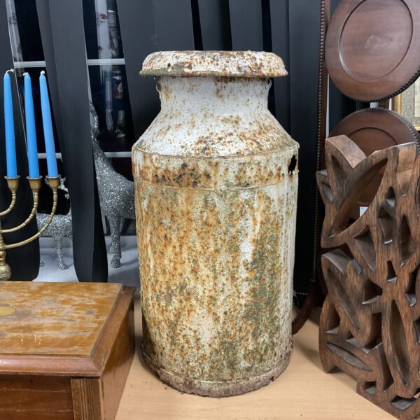 Large vintage milk churn, a rustic piece of farm equipment.