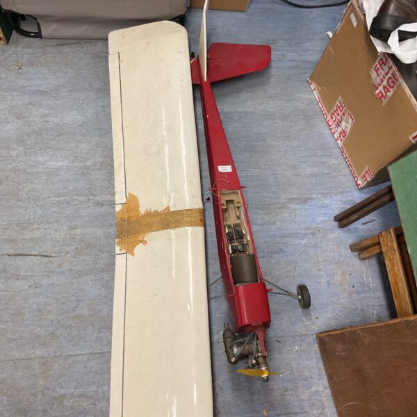 Red vintage model airplane for restoration project.