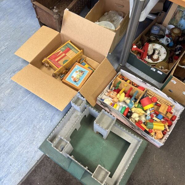 Overview of vintage model fort and boxes of wooden toys.