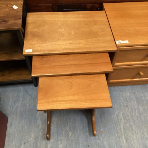Vintage wooden nest of tables in graduated sizes.