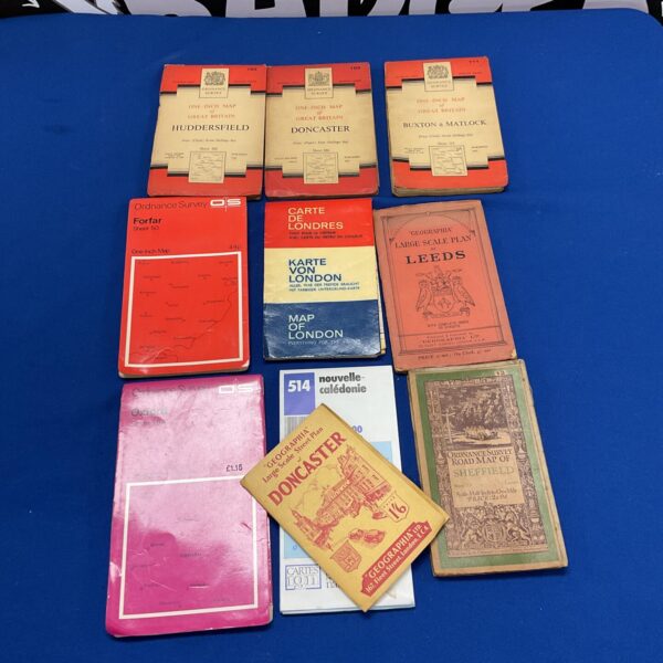 Collection of vintage Ordnance Survey maps and topographical charts.