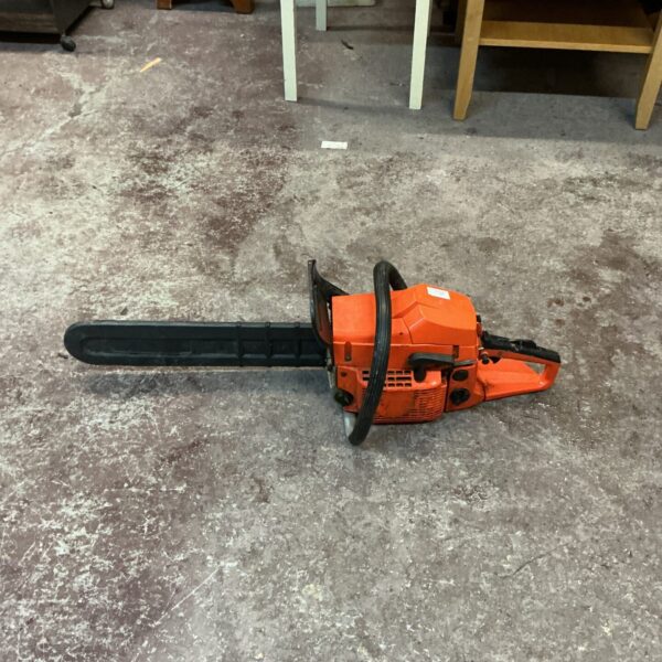 Vintage petrol chainsaw for garden and landscaping, showing signs of wear.