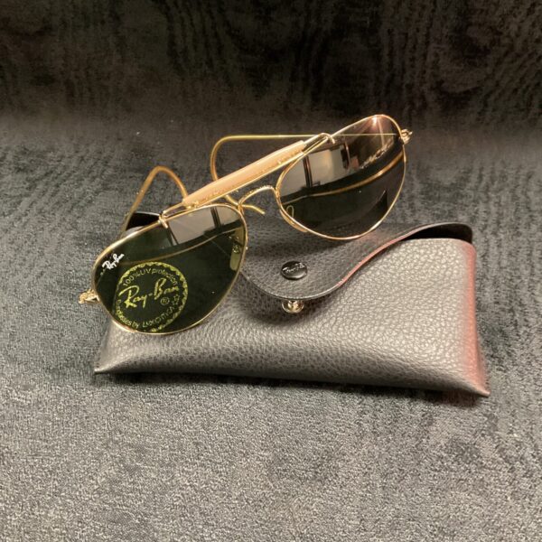 Gold framed vintage Ray Ban Aviator sunglasses, classic 1980s style.