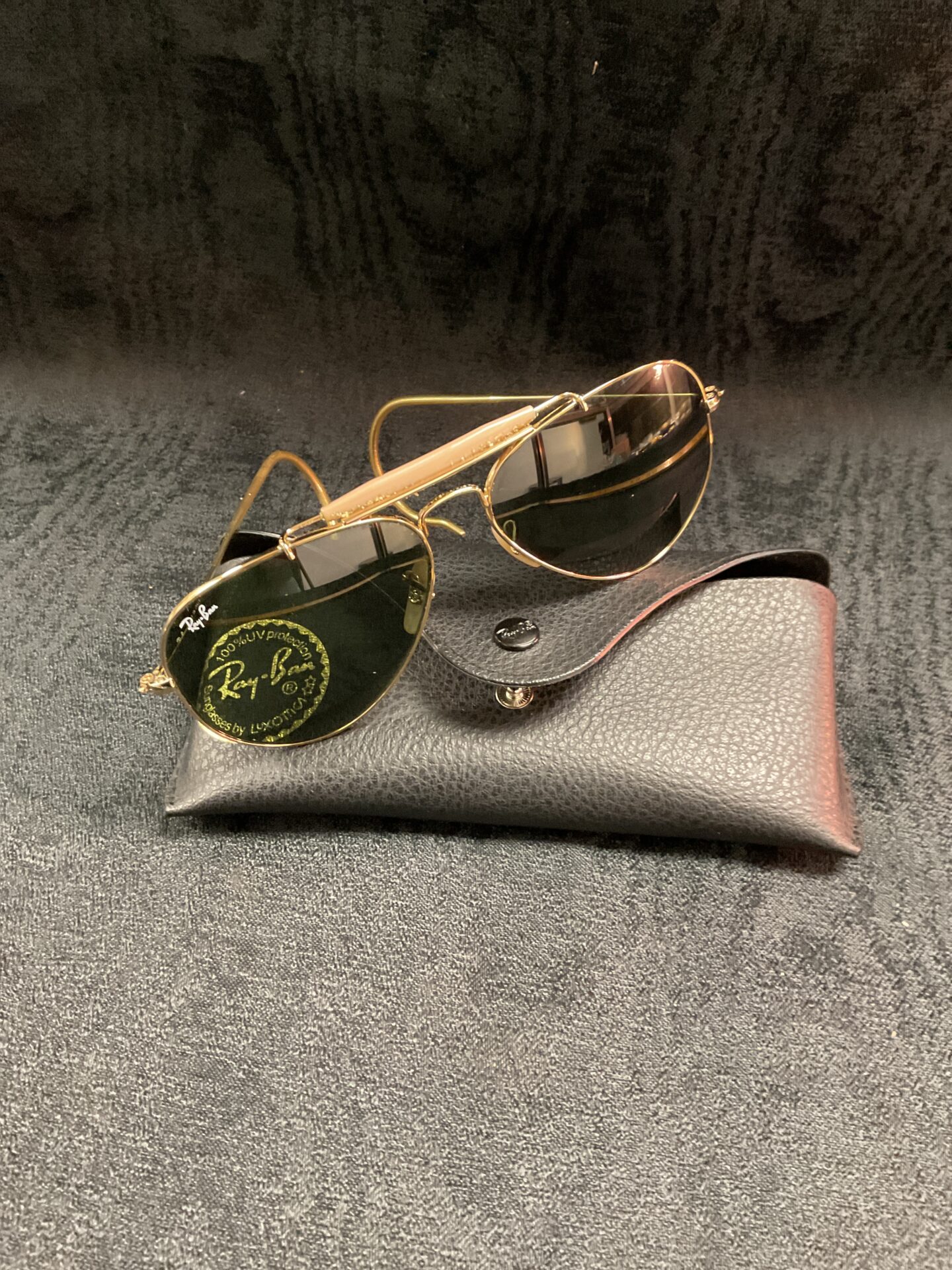 Gold framed vintage Ray Ban Aviator sunglasses, classic 1980s style.