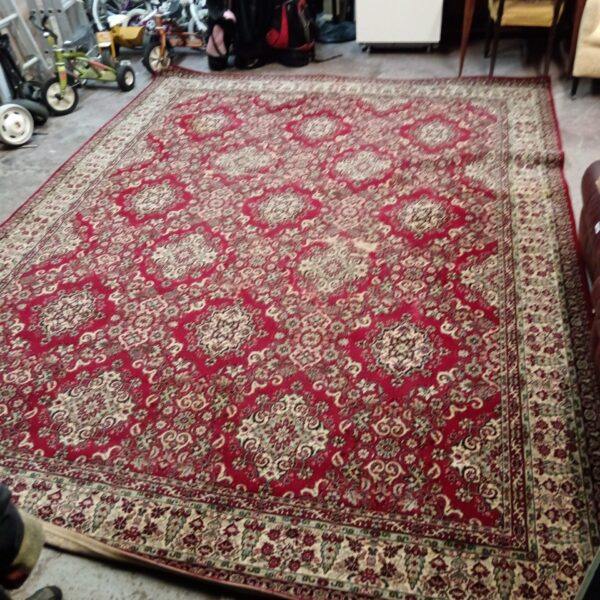 Large vintage red Persian rug with floral patterns.