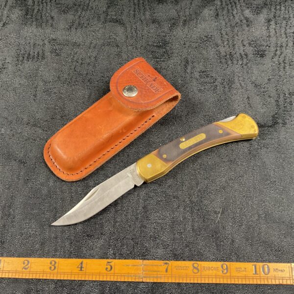 Vintage Schrade pocket knife with leather sheath, classic folding knife.