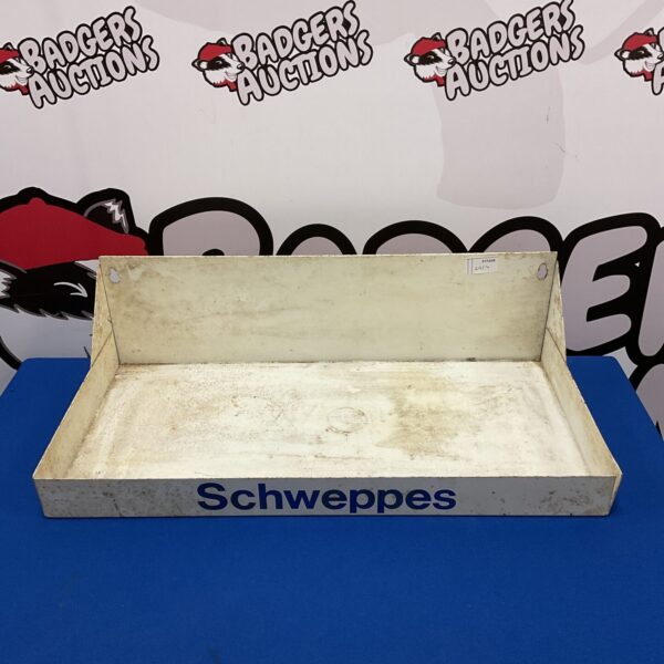 Vintage metal Schweppes bottle display stand for collectible advertising.