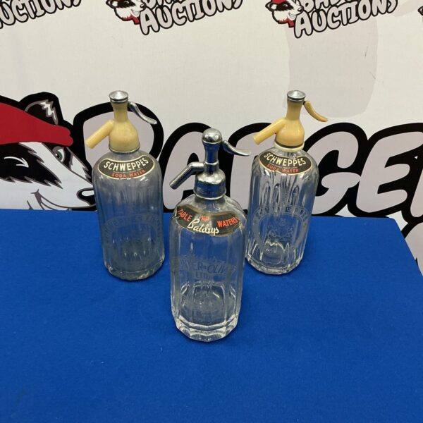 Vintage soda syphon with metal top, antique glass bottle.