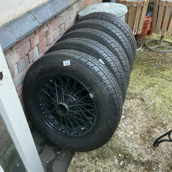 Set of four vintage spoked car wheels for classic cars.
