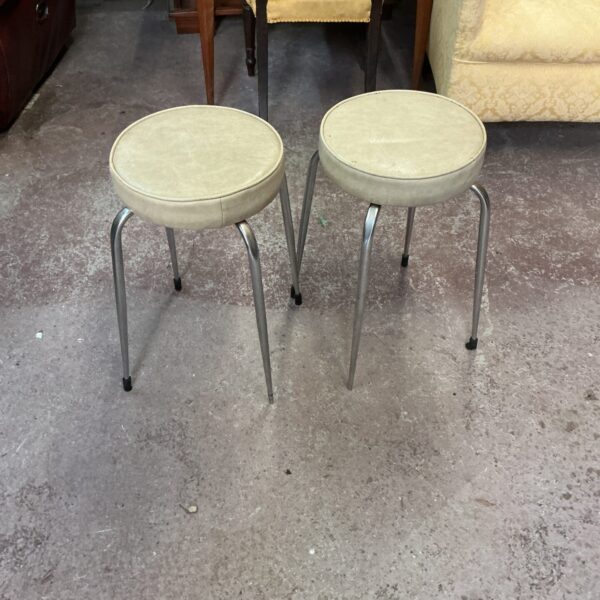 Pair of vintage stools with neutral seats and slender legs.