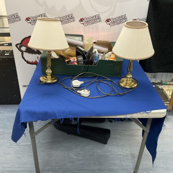 Two vintage brass table lamps with a box of items.