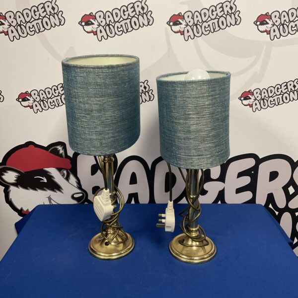 Pair of vintage table lamps with cream shades and brass bases.