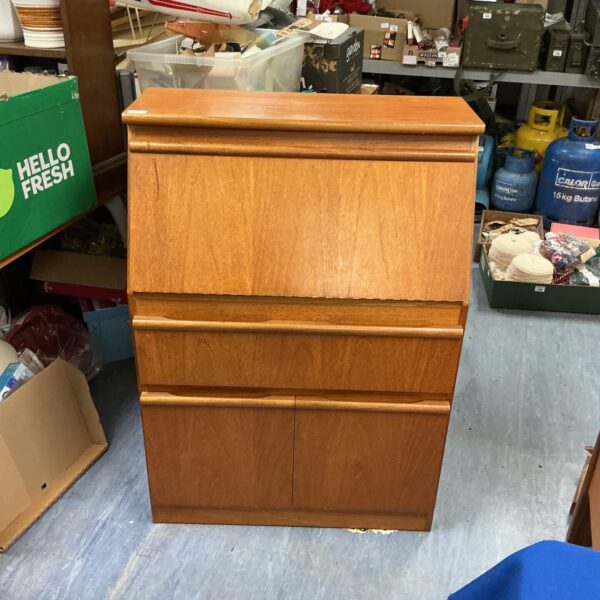 Front view of a vintage teak bureau with two drawers.