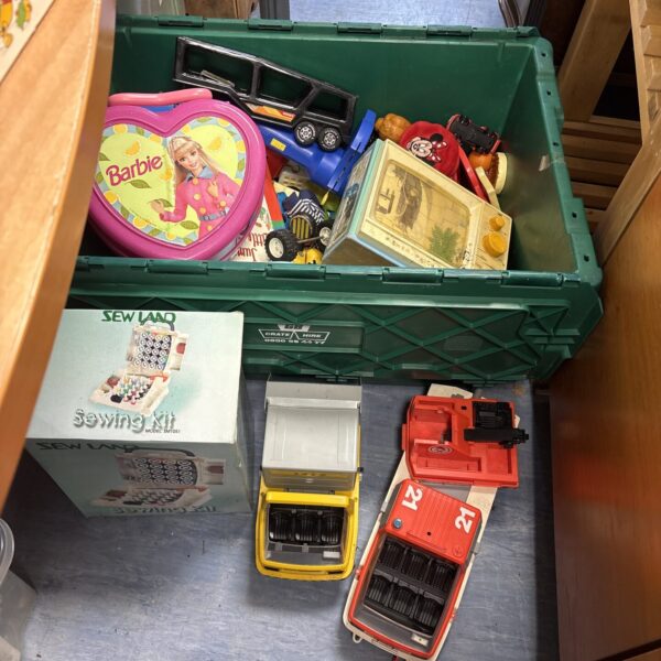 Overview of a vintage toy lot with Barbie and diecast cars.