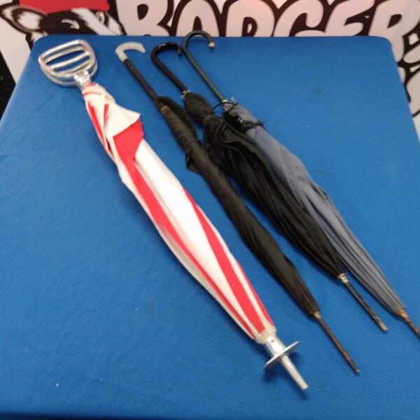 Vintage umbrella lot featuring shooting stick umbrella and other styles.