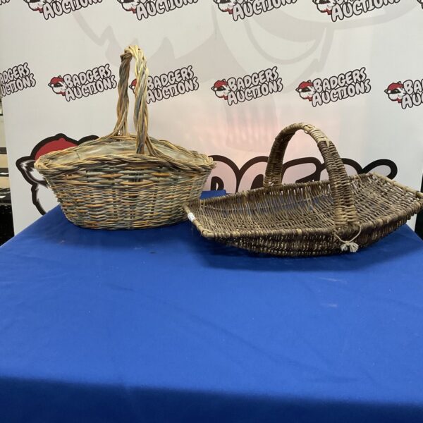 Two vintage wicker baskets with handles, ideal for farmhouse decor.