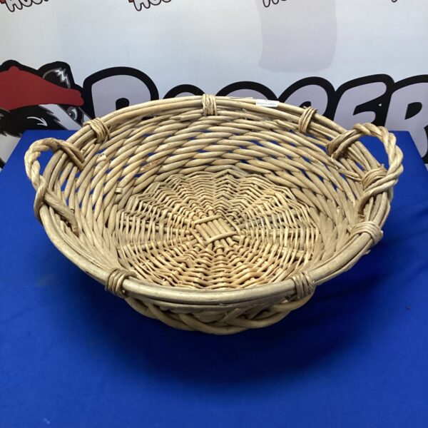 Vintage wicker fruit basket for display and storage.
