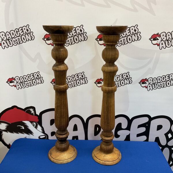 Pair of vintage wooden candlesticks for home decor.