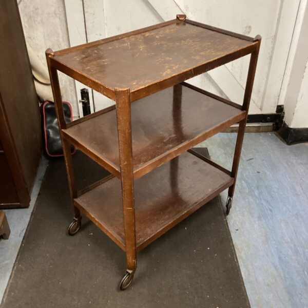 Vintage wooden hostess trolley with three tiers and castors.