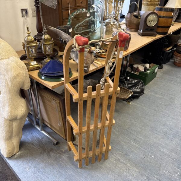 Vintage wooden Metro-Davos sledge with woven rails.