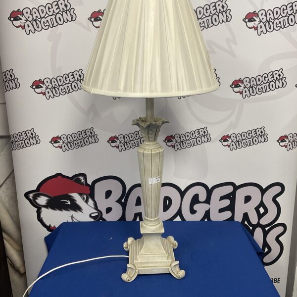 Vintage wooden table lamp with cream shade and carved base.