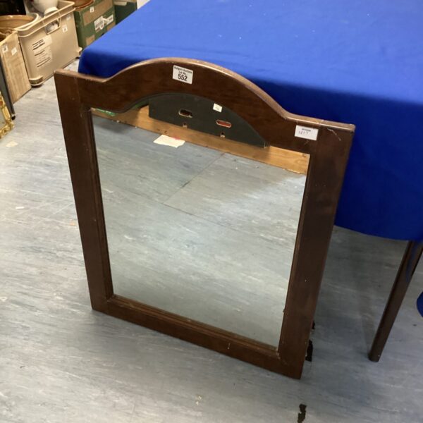 Vintage wooden wall mirror with a classic frame.