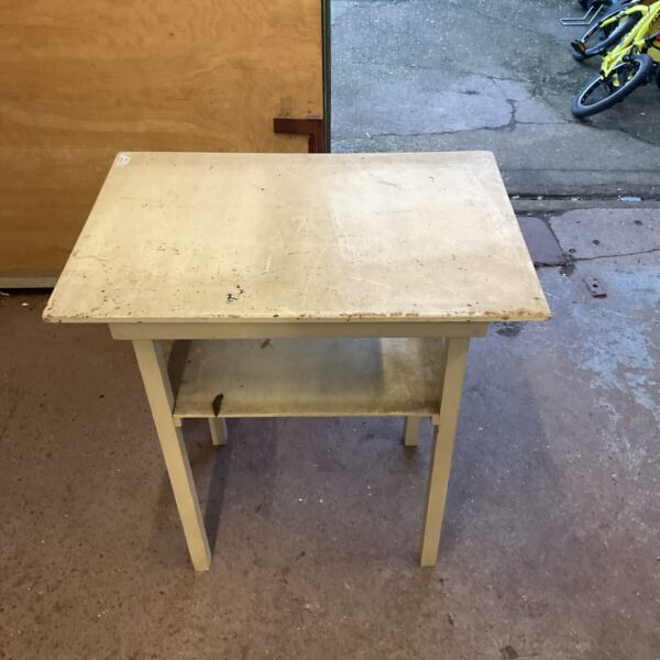 Vintage yellow side table with a single shelf.