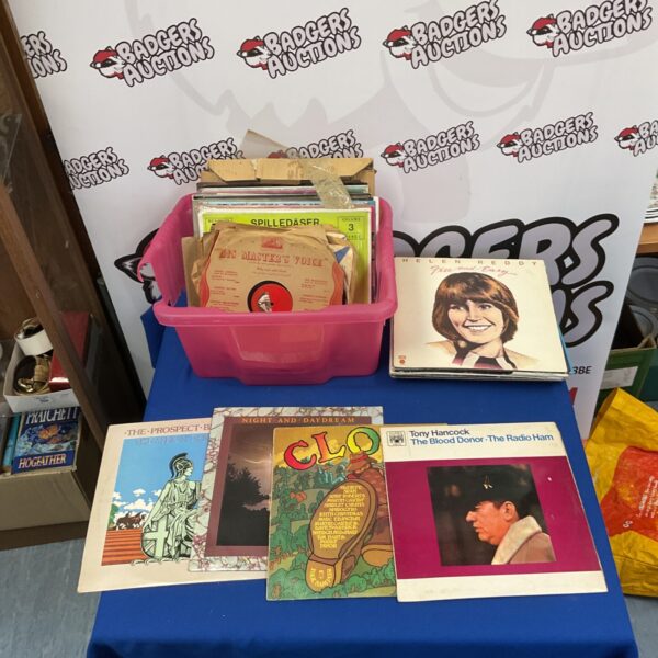 Mixed lot of vinyl records with various genres and sizes.