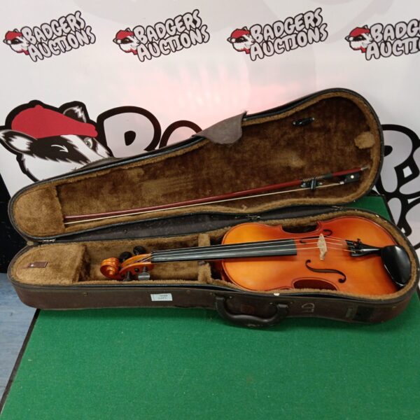Vintage wooden violin with bow inside a protective case.