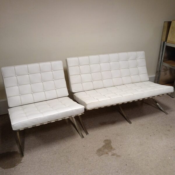 Pair of white leather Barcelona chairs, mid-century modern design.