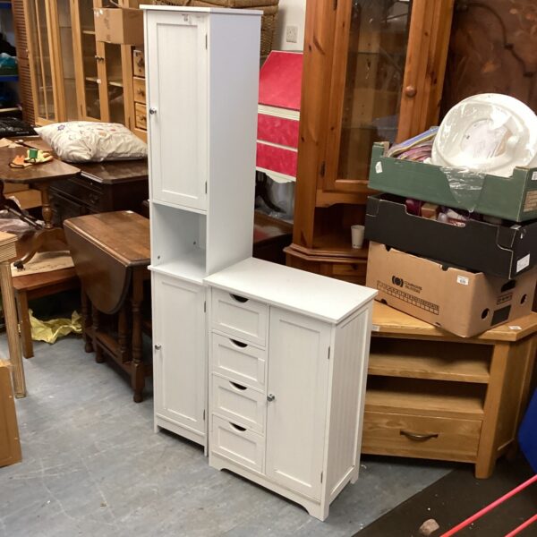 White bathroom cabinet with a single door, offering practical storage.
