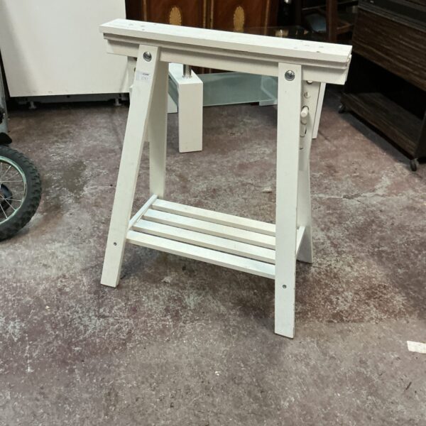 White wooden trestle table support for displays and projects.