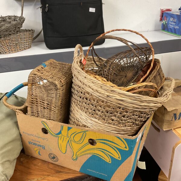 Assorted vintage wicker baskets for storage and display.