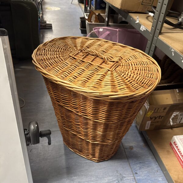 Tall wicker laundry basket with woven texture.