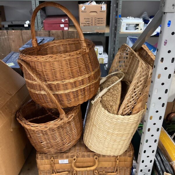 Lot of natural wicker and seagrass baskets for storage and shopping.