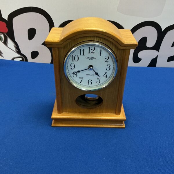 Vintage William Widdop mantle clock on display.