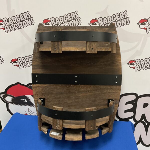 Rustic wine barrel wall rack for storing wine bottles.
