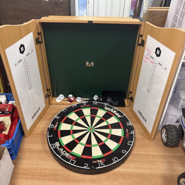Winmau Blade 116 dartboard in wooden case, showing signs of use.