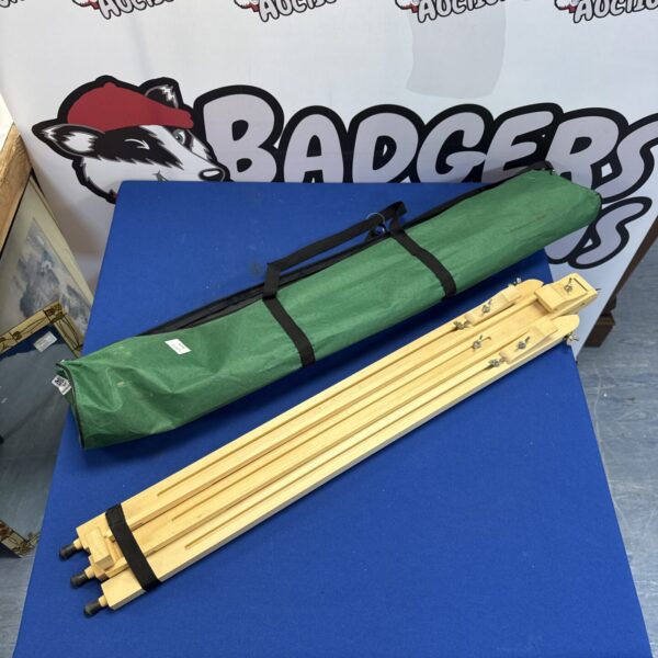Wooden folding artist easel with green carry case.