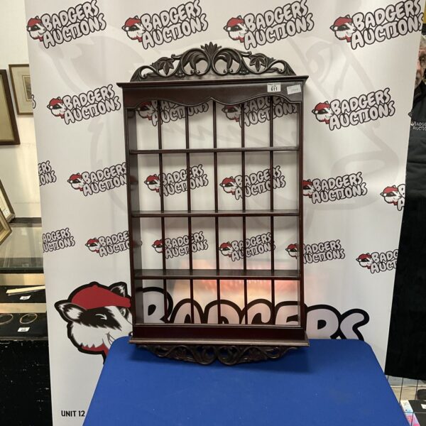 Tiered wooden wall shelf for displaying collectibles and home decor.