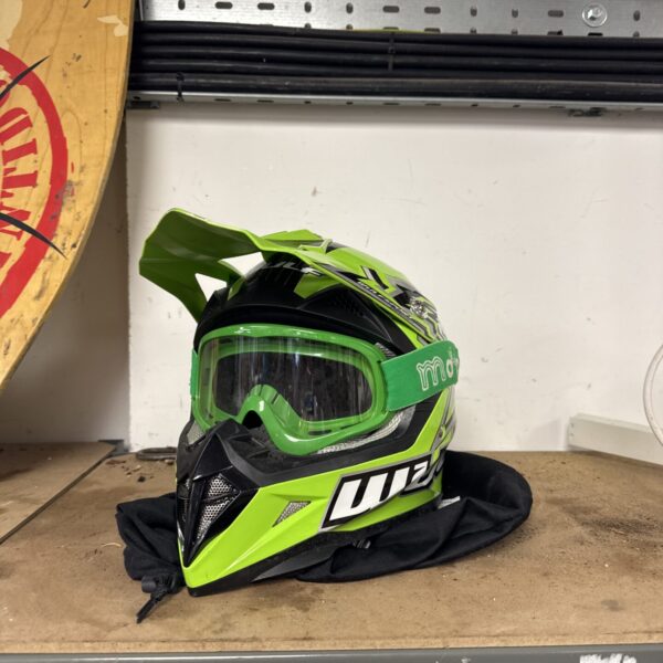 Front view of a green and black Wulf motocross helmet with goggles.